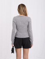 Gray wrap sweater with buttons on the side.