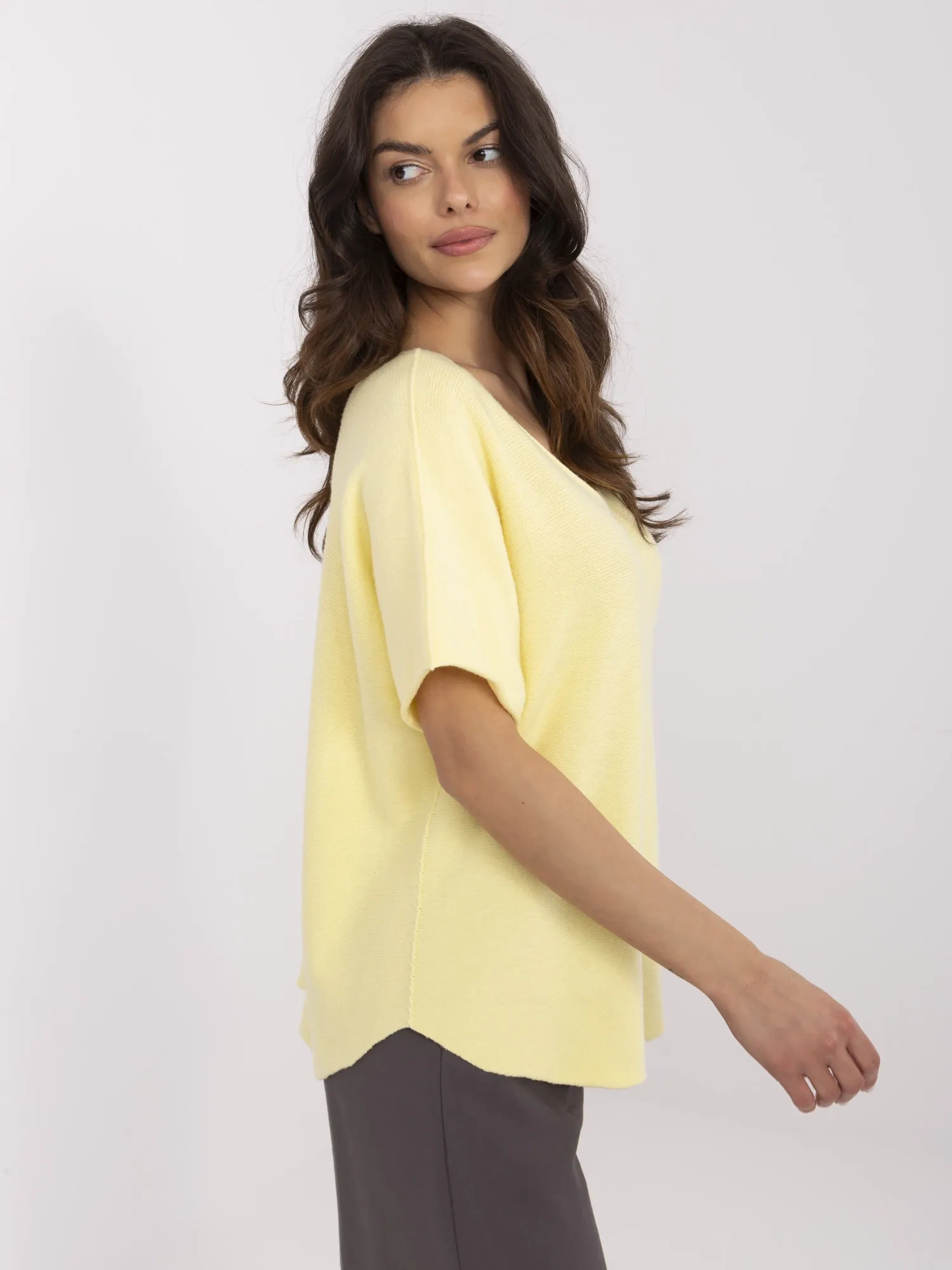 Light yellow reversible sweater with a V-neck.