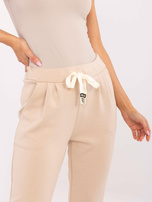 Hurt Beżowe dresowe spodnie damskie z wiązaniem