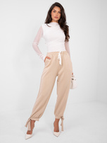 Beżowe dresowe spodnie ze ściągaczami 