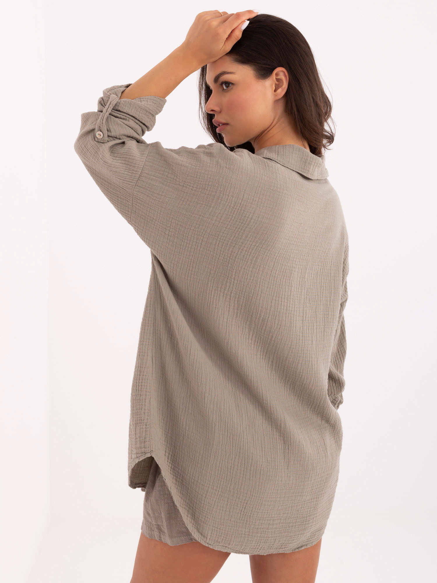 Dark beige button-up muslin shirt.