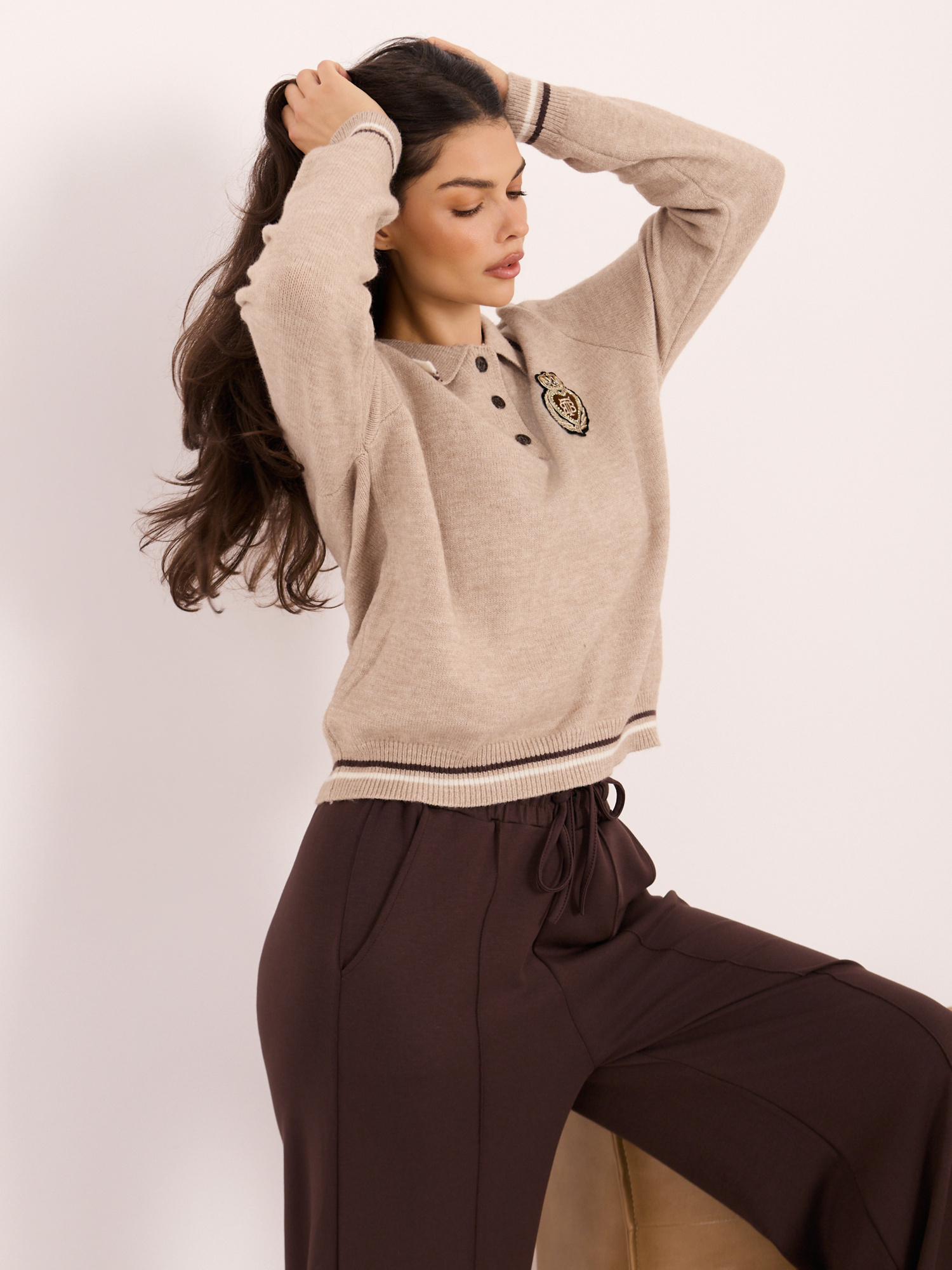 Beige women's polo sweater in college style.