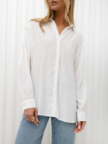 Ecru button-up basic shirt with long sleeves.