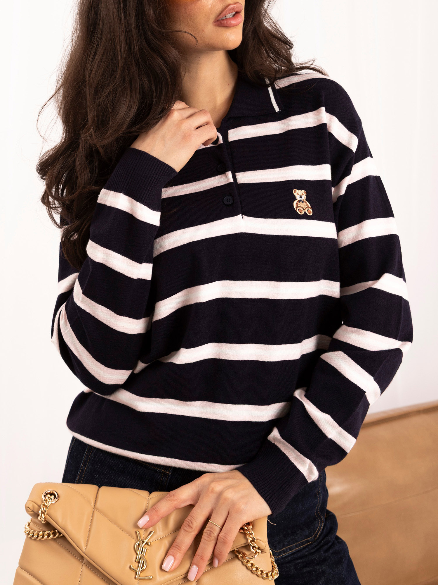 Navy women's polo sweater with bear embroidery.