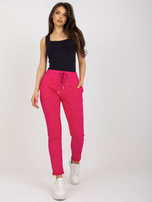 Hurt fuchsia sweatpants with decorative buttons.