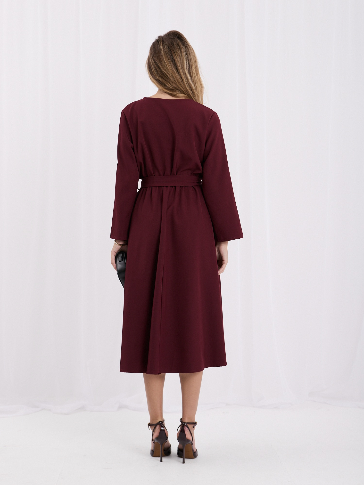 Burgundy elegant dress with decorative buttons.