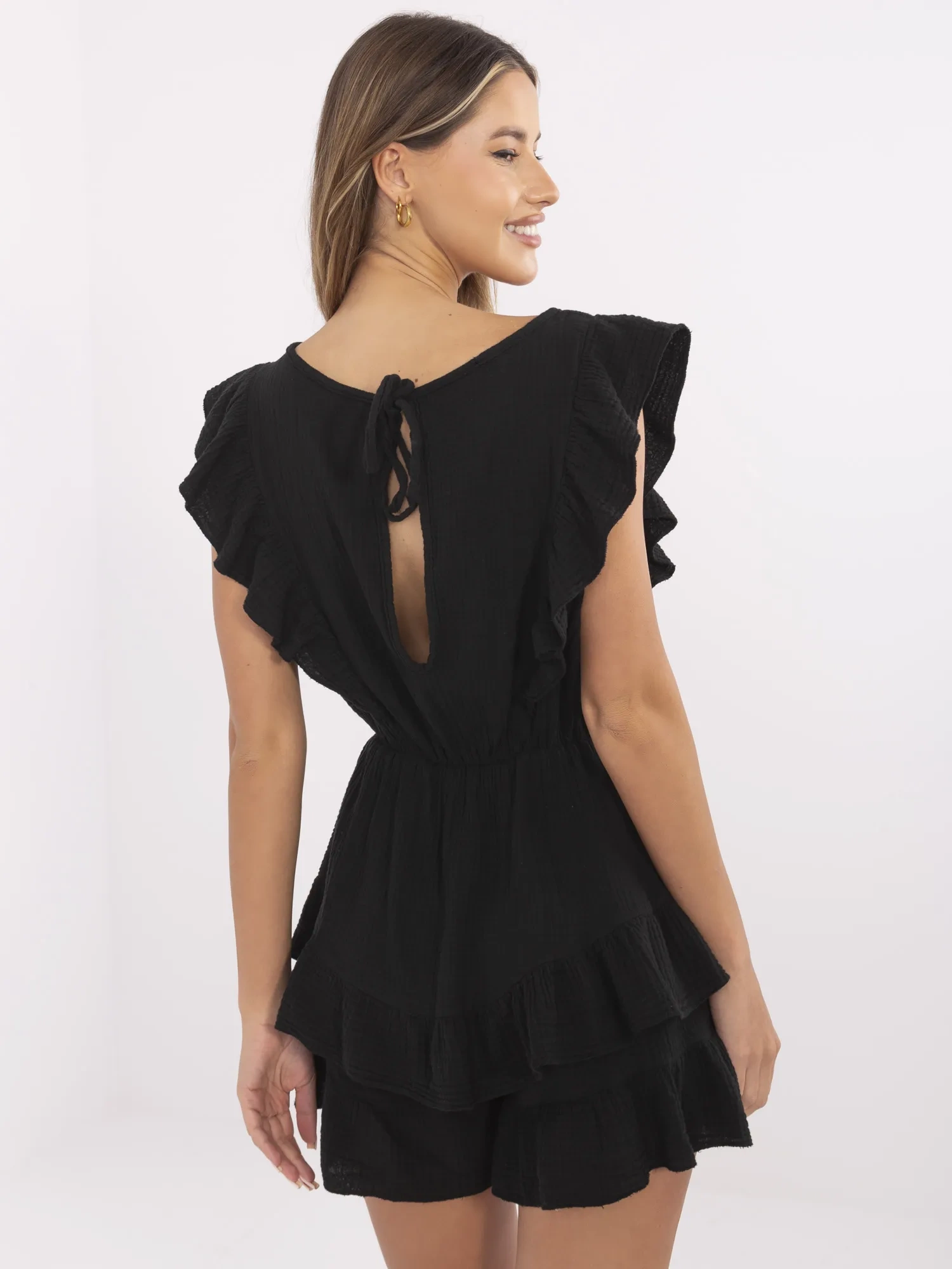Black muslin jumpsuit with ruffles.