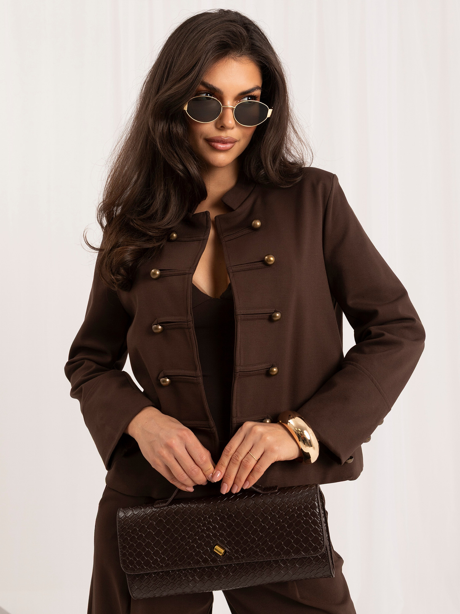 Brown suit with decorative double-breasted fastening.