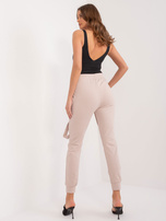 Hurt Beżowe spodnie dresowe z kieszeniami