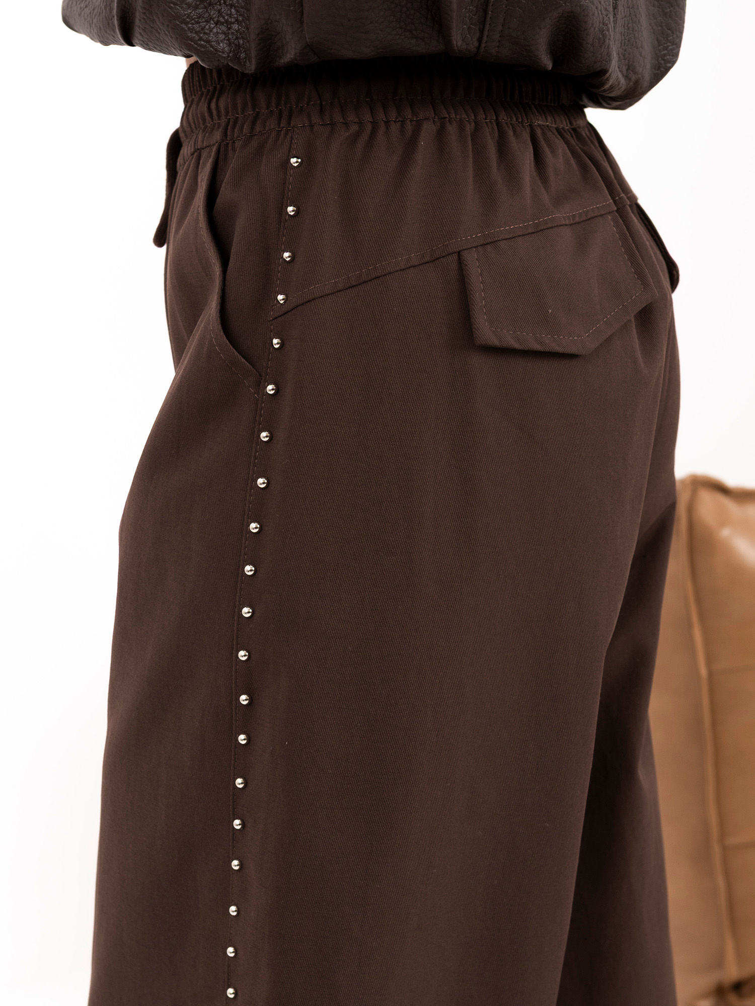 Brown wide-leg pants with elastic cuffs.