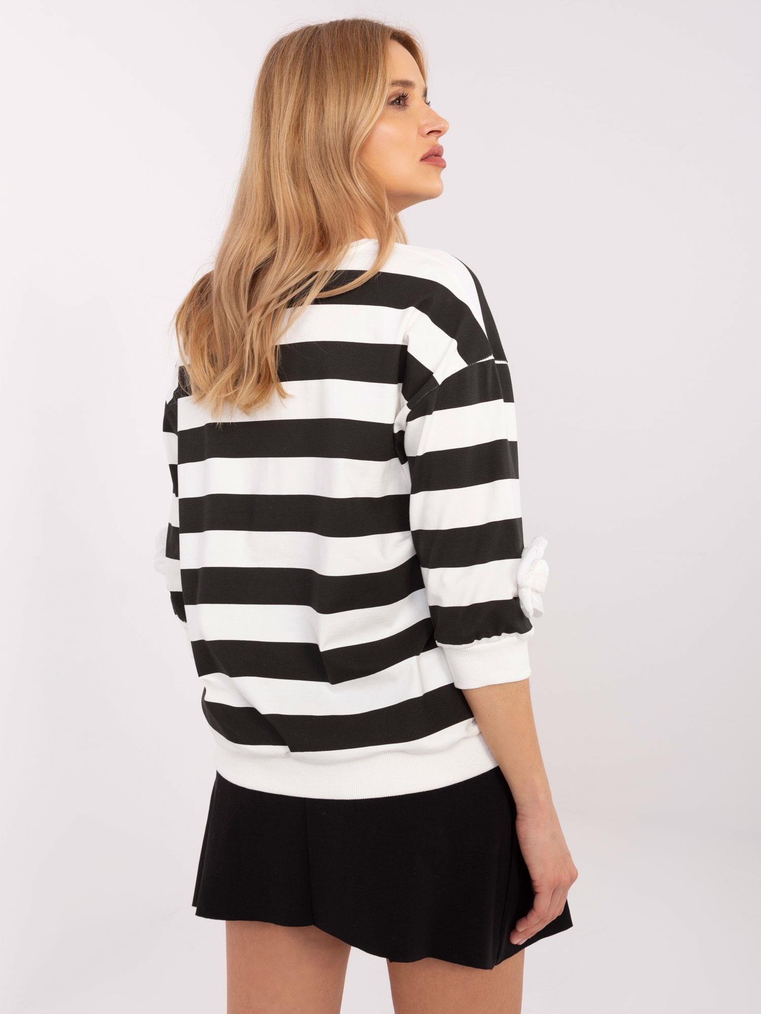Wholesale black-ecru blouse with a round neckline.
