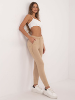 Hurt Beżowe damskie spodnie dresowe z kieszeniami