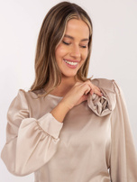 Beige satin blouse with puffed sleeves.