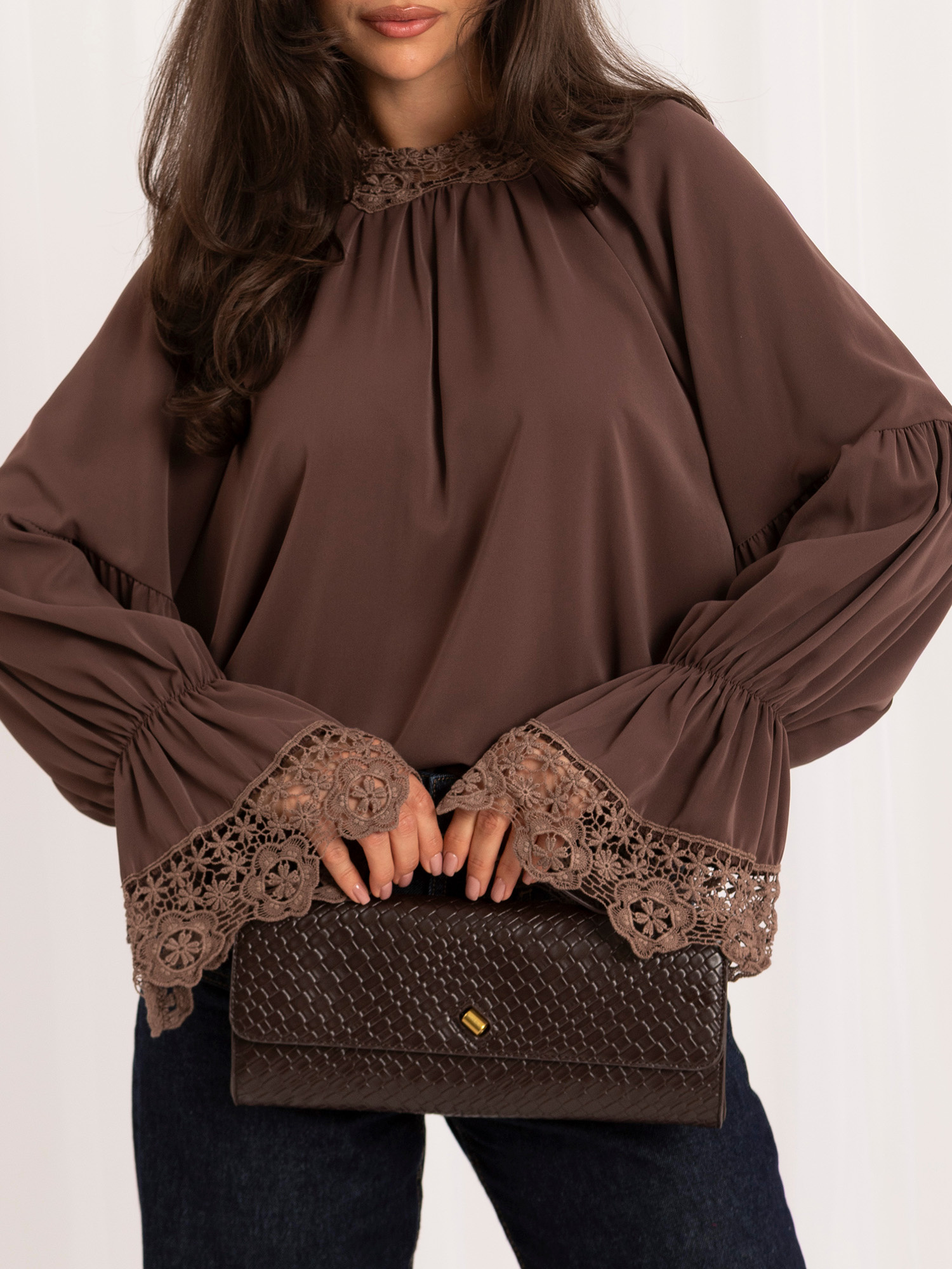 Dark beige blouse with a bow on the back.