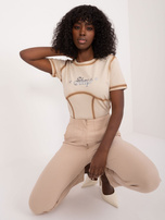 Beige women's t-shirt with embossed lettering.