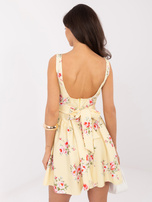 Light yellow mini dress for a wedding.