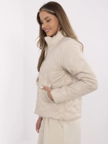 Beige quilted women's jacket with a stand-up collar.