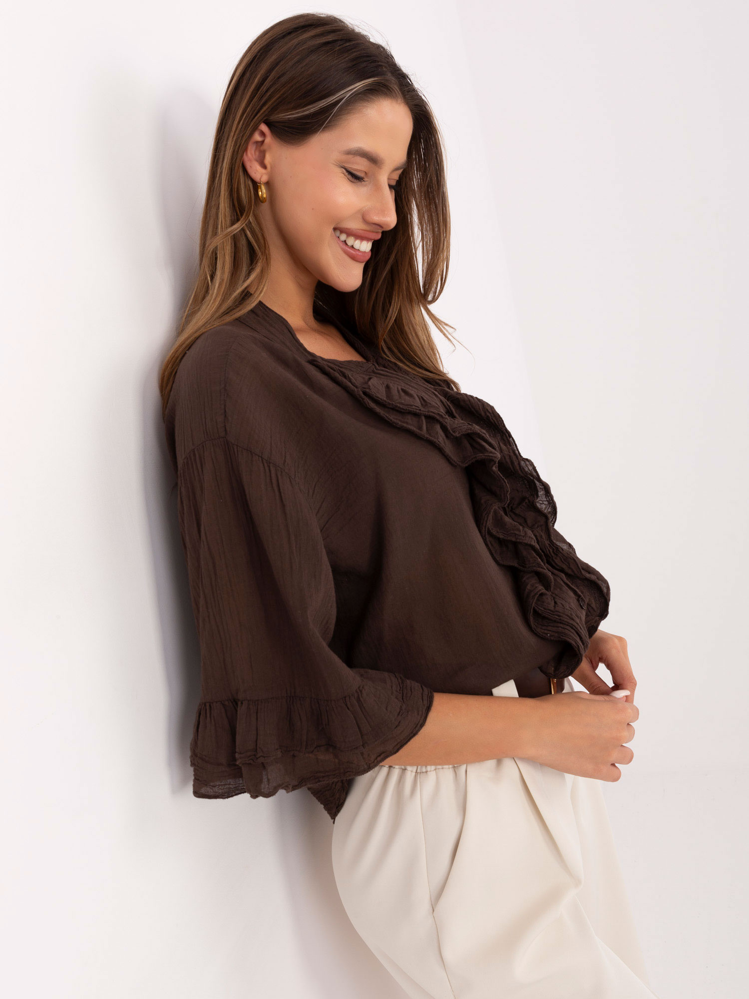 Dark brown flowing shirt with a ruffle.