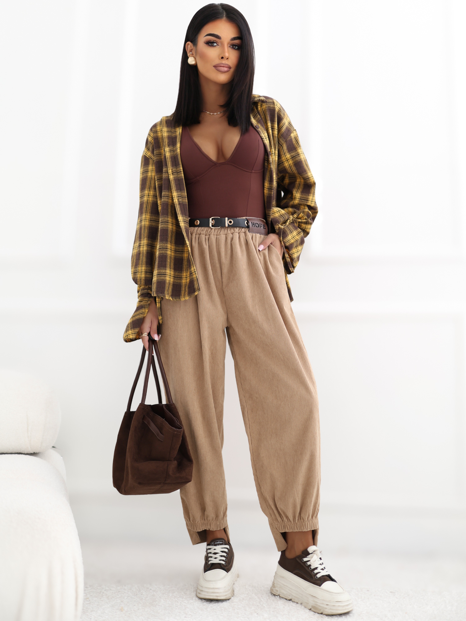 Yellow checkered shirt with decorative ties at the cuffs.