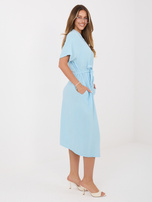 Light blue muslin dress with a tied belt.
