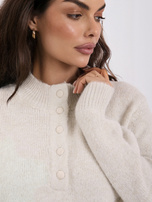 Light beige oversized women's sweater made of fluffy knit.