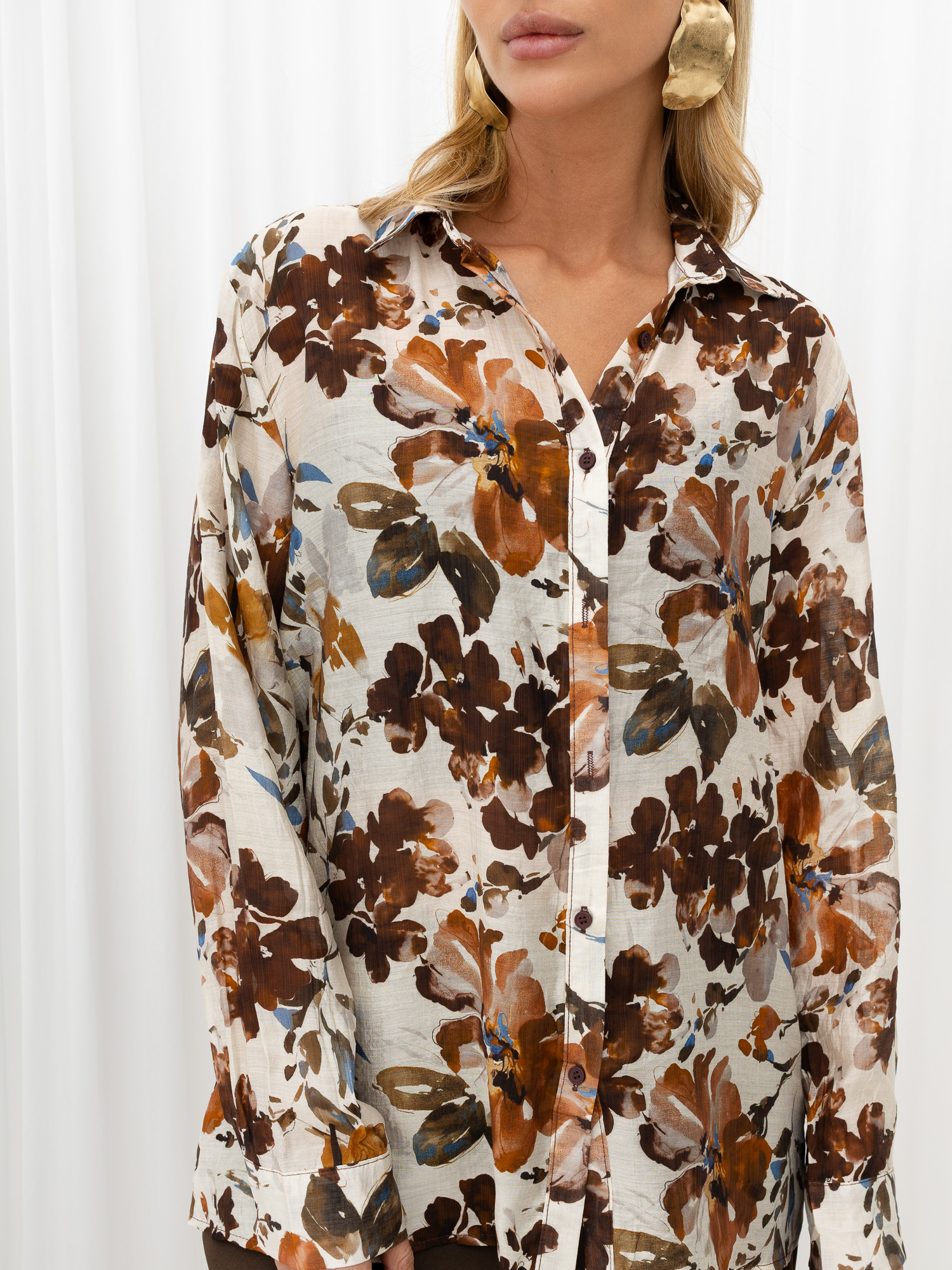 Brown button-up shirt in floral pattern.