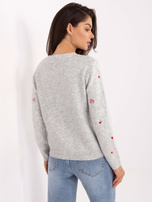 Light gray sweater with a round neckline.